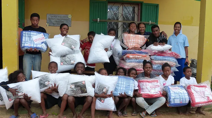 Groupe souriant recevant des colis humanitaires à Madagascar